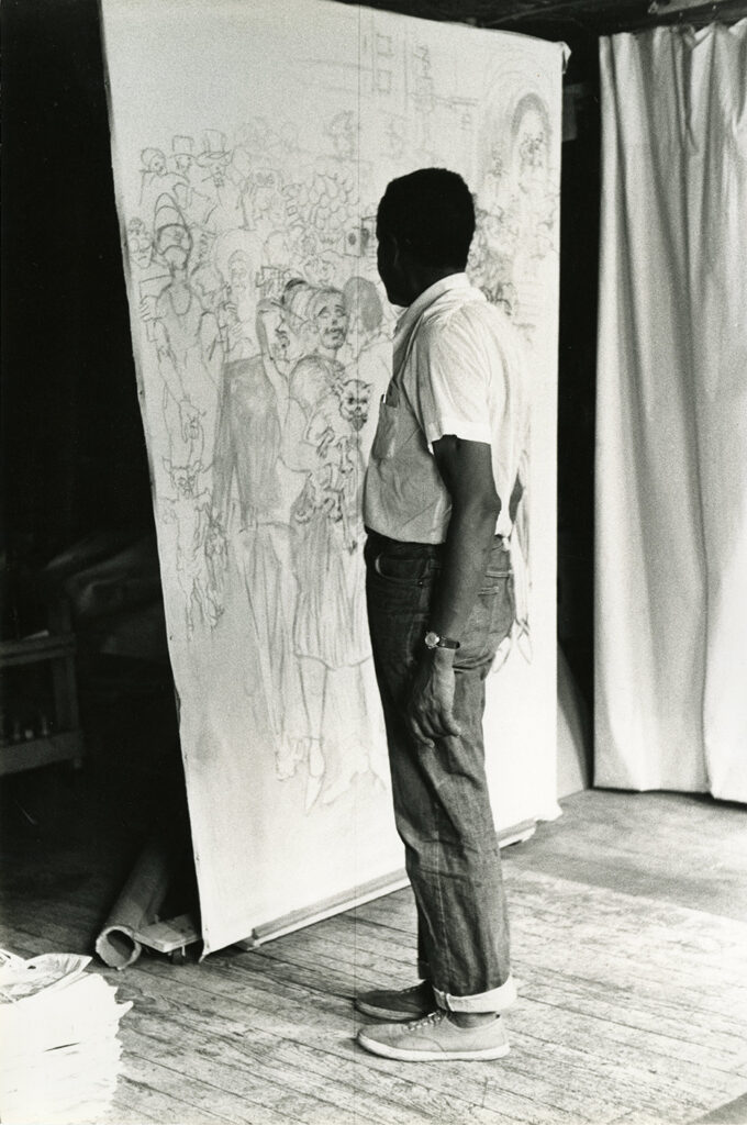 Artist Joe Delaney contemplates one of his in-process canvases