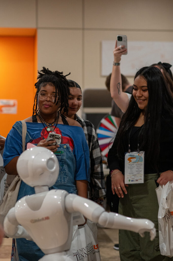 BOSS students interact with a robotic Dolly Parton