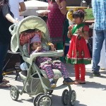 photo of young girl and a baby in a stroller