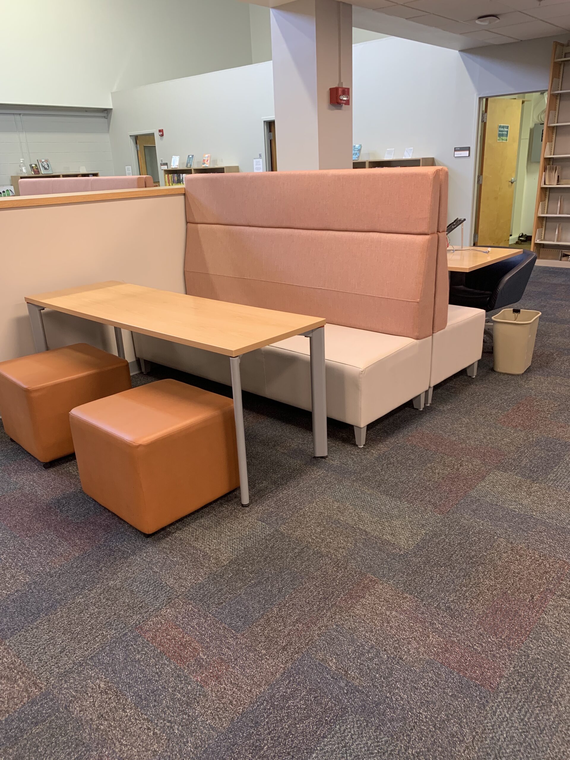 Rectangular table with lounge chairs and booth seating